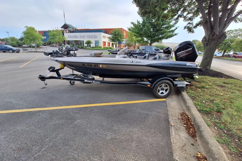 Slide: The Image of 2000 Triton Tr-17 boat on trailer in parking lot near Tracker Boat Center. - 3