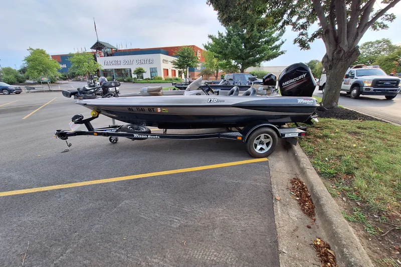 Slide: The Image of 2000 Triton Tr-17 boat on trailer in parking lot near Tracker Boat Center. - 4