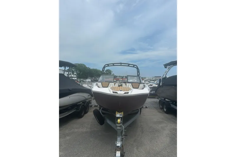 Slide: The Image of 2023 Yamaha Boats 252S on trailer, displayed outdoors under cloudy sky. - 6
