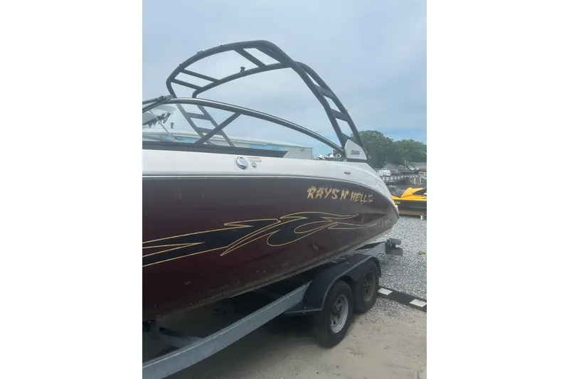 Slide: The Image of 2023 Yamaha Boats 252S on trailer, featuring custom graphics and sleek design. - 10