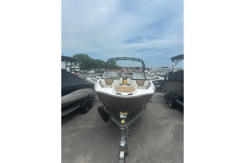 Slide: The Image of 2023 Yamaha Boats 252S on trailer, parked outdoors under a cloudy sky. - 4