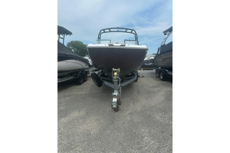 Slide: The Image of 2023 Yamaha Boats 252S on trailer, front view, parked outdoors. - 5