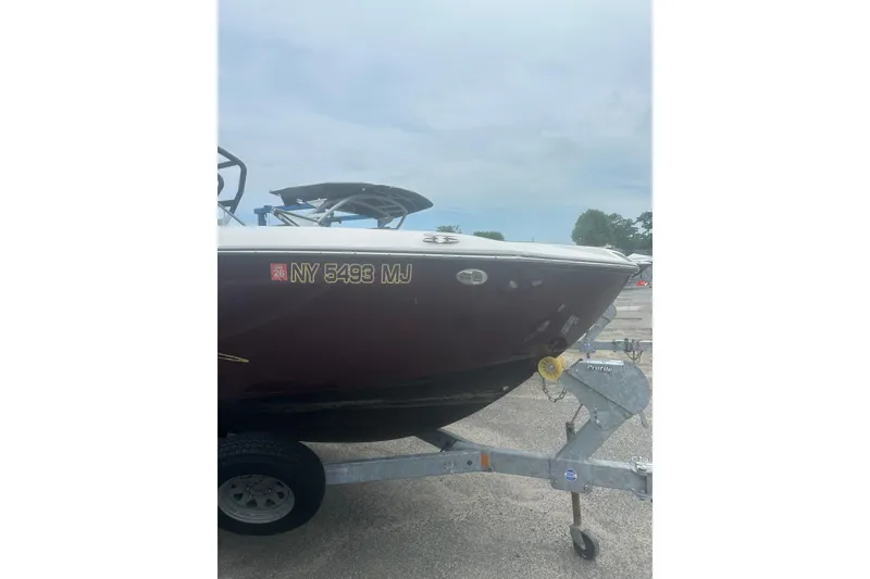 Slide: The Image of 2023 Yamaha Boats 252S on trailer, side view with registration number visible. - 12