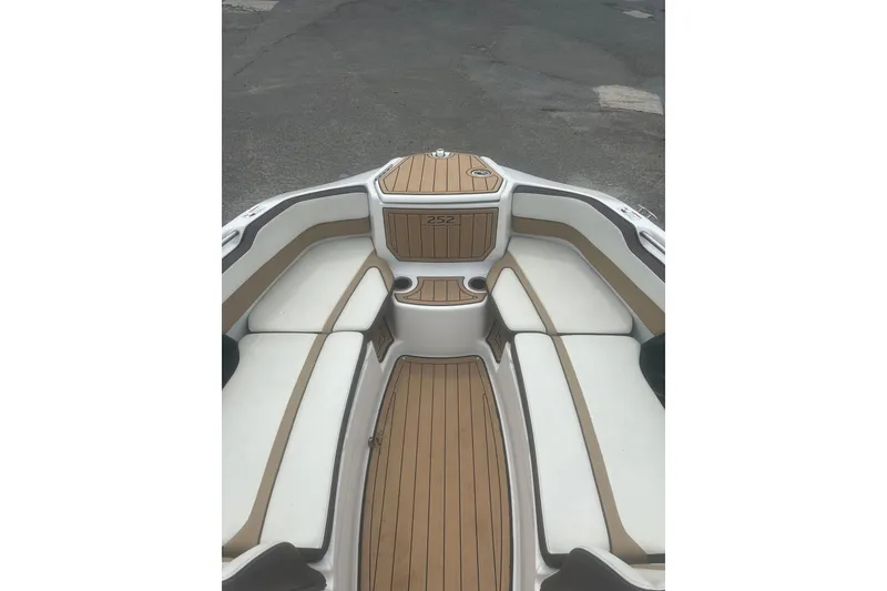 Slide: The Image of 2023 Yamaha Boats 252S interior with sleek seating and wood-style flooring. - 27