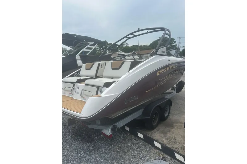Slide: The Image of 2023 Yamaha Boats 252S on trailer, rear view, sleek design, outdoor setting. - 8