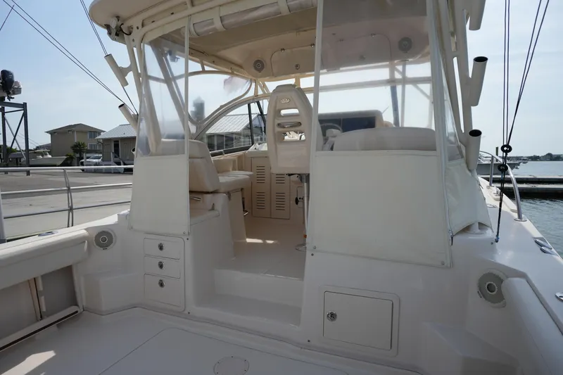 Slide: The Image of 2018 Grady-White Express 330 boat interior with helm and seating area at marina. - 15