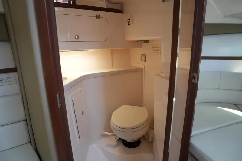 Slide: The Image of 2018 Grady-White Express 330 boat interior with compact bathroom and seating area. - 30