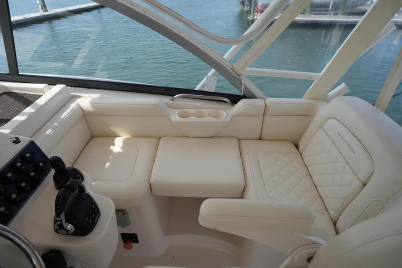 Slide: The Image of Luxurious seating area on a 2018 Grady-White Express 330 boat, featuring cream upholstery. - 20