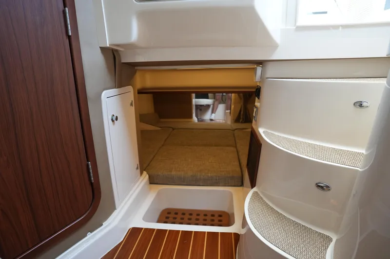 Slide: The Image of 2018 Grady-White Express 330 cabin interior with cozy sleeping area and wooden accents. - 33