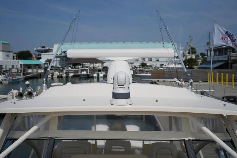 Slide: The Image of 2018 Grady-White Express 330 boat docked at marina with radar equipment. - 38