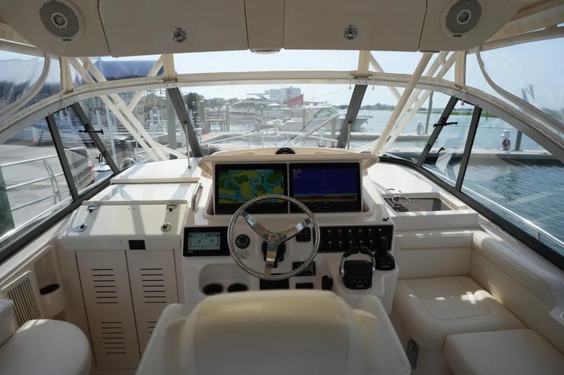 Slide: The Image of 2018 Grady-White Express 330 helm with navigation screens and luxurious seating. - 21