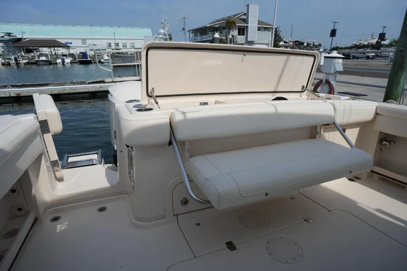 Slide: The Image of 2018 Grady-White Express 330 boat interior with foldable seating at marina. - 14