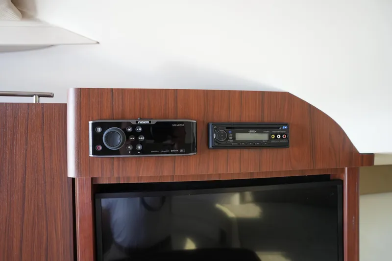Slide: The Image of 2018 Grady-White Express 330 interior with wood paneling and audio system. - 36