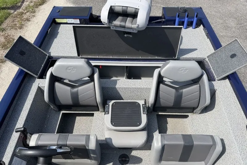 Slide: The Image of 2023 G3 Sportsman 1710 boat interior with gray seating and storage compartments. - 14
