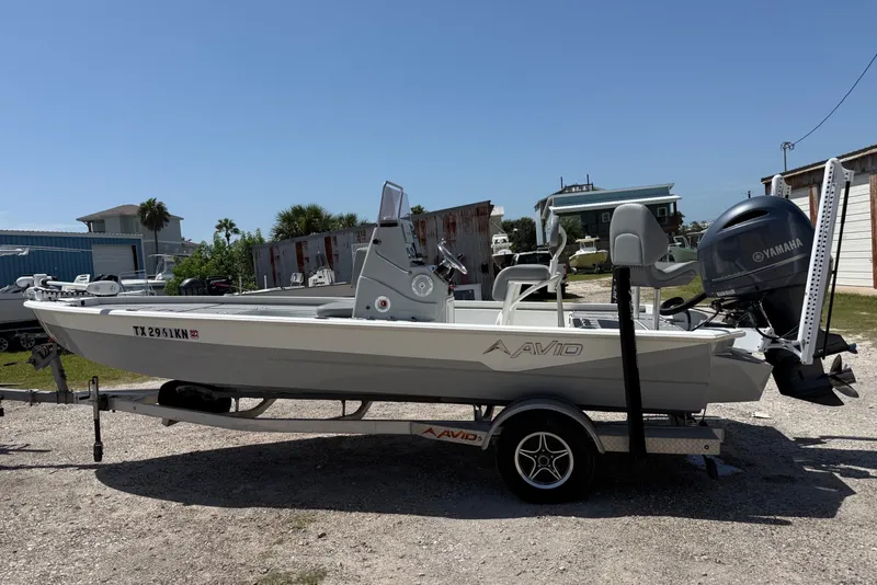 The Image of 2022 Avid 21 FST boat on trailer with Yamaha outboard motor, parked outdoors. - 0