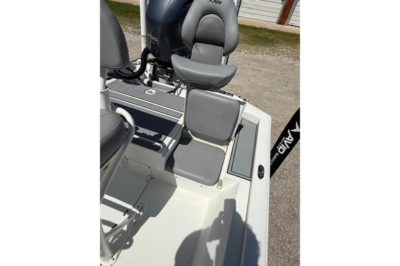 Slide: The Image of The image shows the seating area of a 2022 Avid 21 FST boat with gray upholstery. - 20