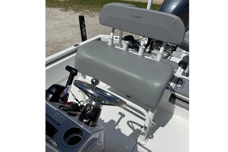 Slide: The Image of 2022 Avid 21 FST boat interior with steering wheel and seating. - 16
