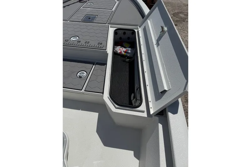 Slide: The Image of Open storage compartment on 2022 Avid 21 FST boat deck with ruler markings. - 15