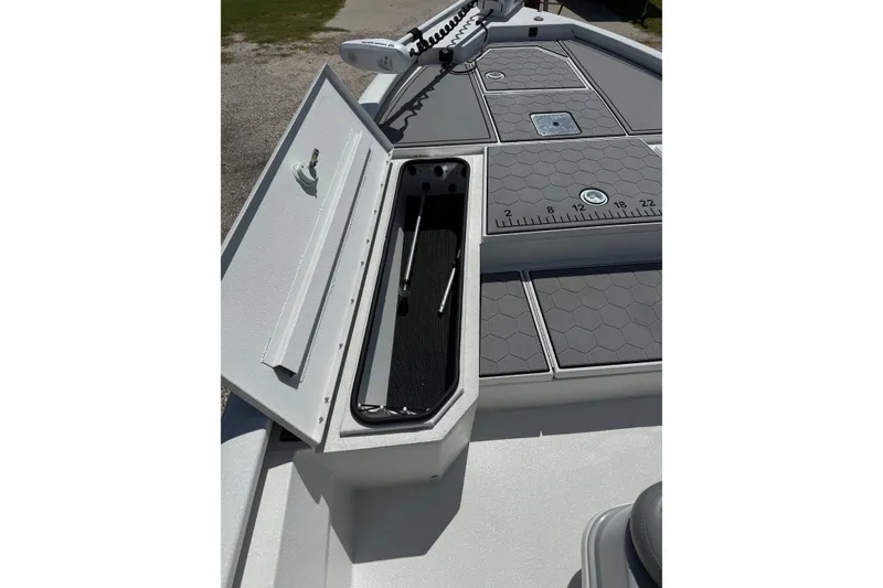 Slide: The Image of 2022 Avid 21 FST boat deck with storage compartment and measuring ruler. - 14