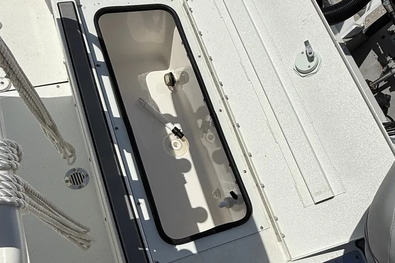 Slide: The Image of Open storage compartment on 2022 Avid 21 FST boat deck with ropes and fittings. - 19