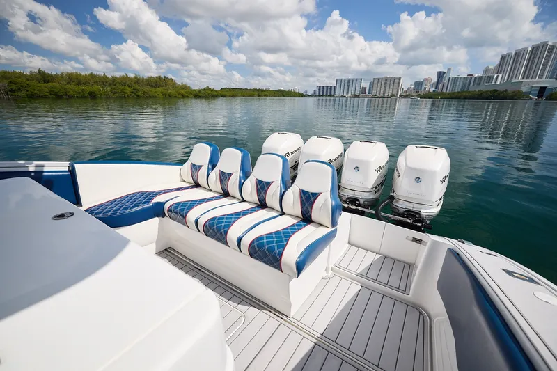 Slide: The Image of 2018 Midnight Express 43 Open boat with stylish seating and powerful outboard engines on a serene waterway. - 14