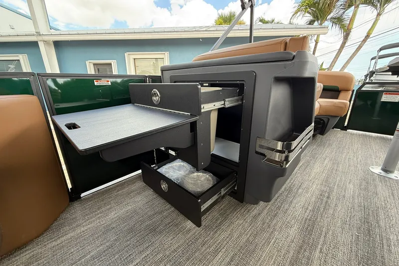Slide: The Image of Bennington 22 M Quad Bench 2027 with open storage compartments and seating, showcasing luxury features. - 11