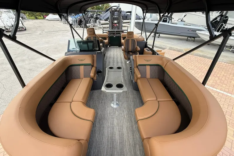 Slide: The Image of Luxurious interior of 2027 Bennington 22 M Quad Bench pontoon boat with tan seating. - 2