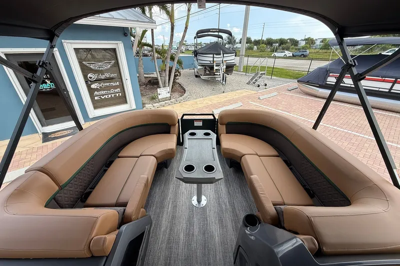 Slide: The Image of 2027 Bennington 22 M Quad Bench pontoon boat with luxurious seating and central table. - 6