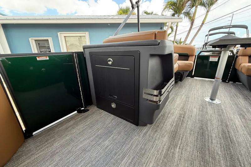 Slide: The Image of 2027 Bennington 22 M Quad Bench interior with modern seating and storage. - 10