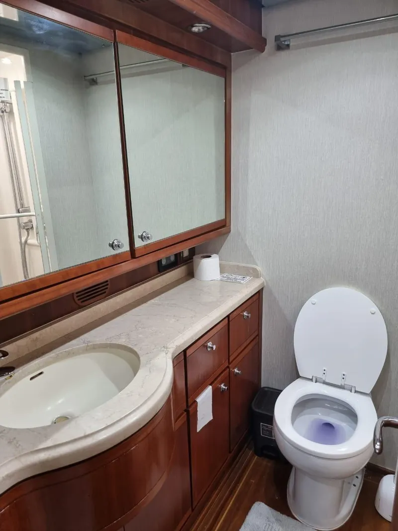 Slide: The Image of 2008 Bertram 670 Convertible yacht bathroom with wooden cabinets and modern fixtures. - 31