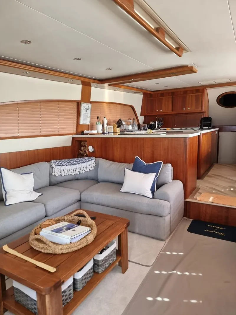 Slide: The Image of Luxurious interior of a 2008 Bertram 670 Convertible yacht with cozy seating area. - 19