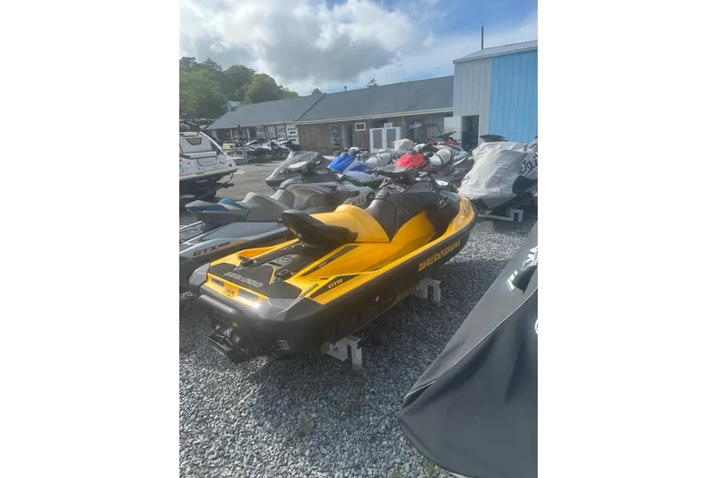 Slide: The Image of 2022 Sea-Doo GTR 230 jet ski in vibrant yellow, parked outdoors. - 6