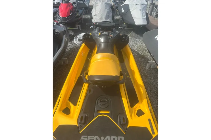 Slide: The Image of 2022 Sea-Doo GTR 230 jet ski in vibrant yellow, parked among other watercraft. - 7
