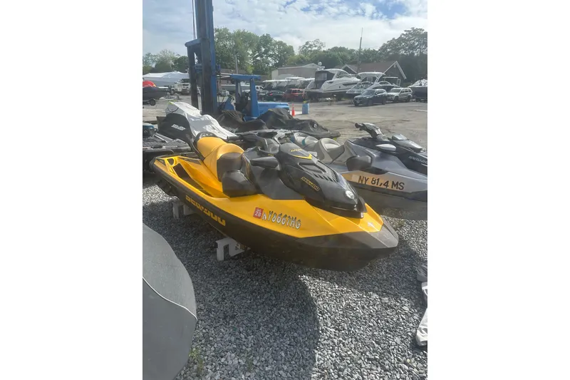 Slide: The Image of 2022 Sea-Doo GTR 230 jet ski in a parking lot, yellow and black design. - 3
