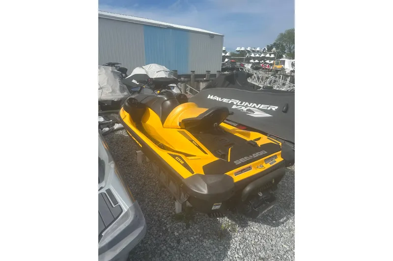 Slide: The Image of 2022 Sea-Doo GTR 230 jet ski in vibrant yellow, parked on gravel. - 5