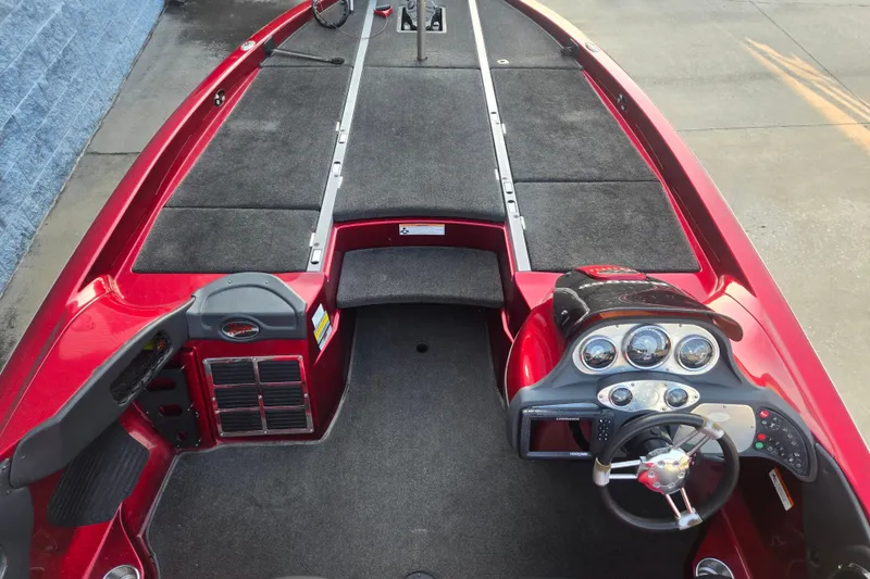 Slide: The Image of Red 2007 Ranger Z21 boat interior with steering wheel and dashboard, featuring spacious deck layout. - 6