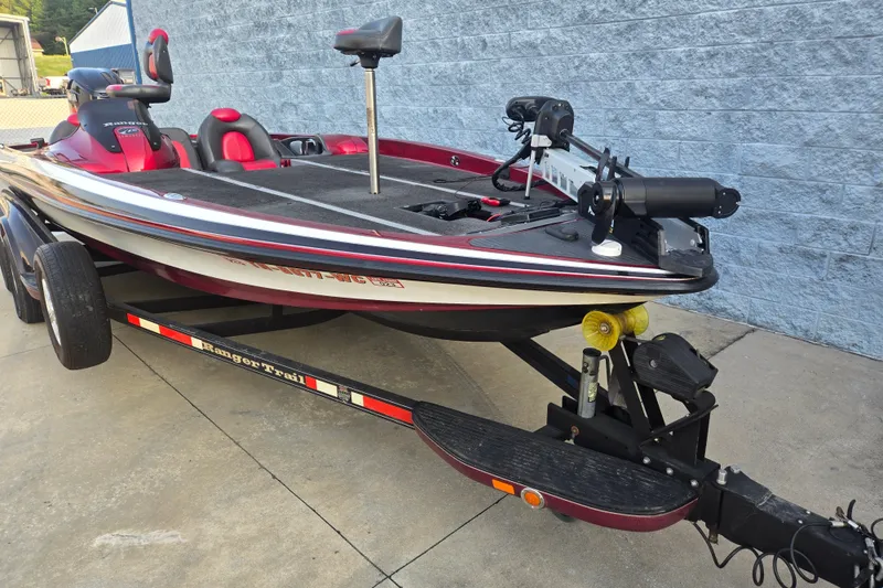 Slide: The Image of 2007 Ranger Z21 boat on trailer, featuring red and black design, parked on concrete. - 4