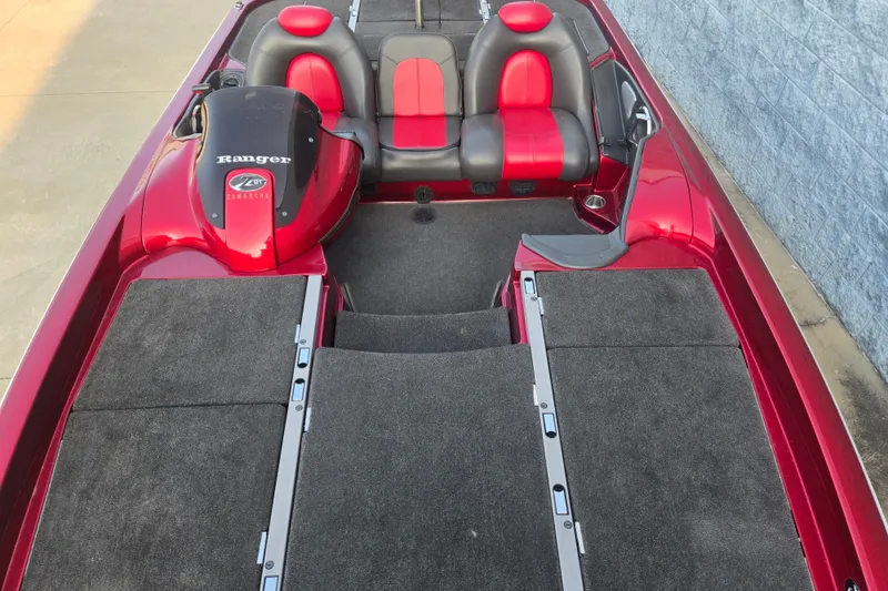 Slide: The Image of 2007 Ranger Z21 boat interior with red and black seating, carpeted deck. - 10