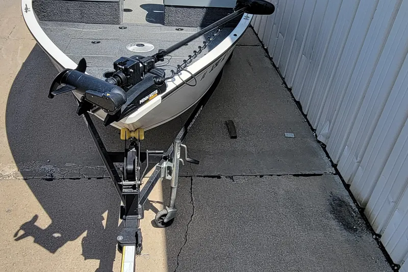 Slide: The Image of 2019 Tracker Pro Guide V-16 WT boat on trailer with Minn Kota trolling motor. - 19