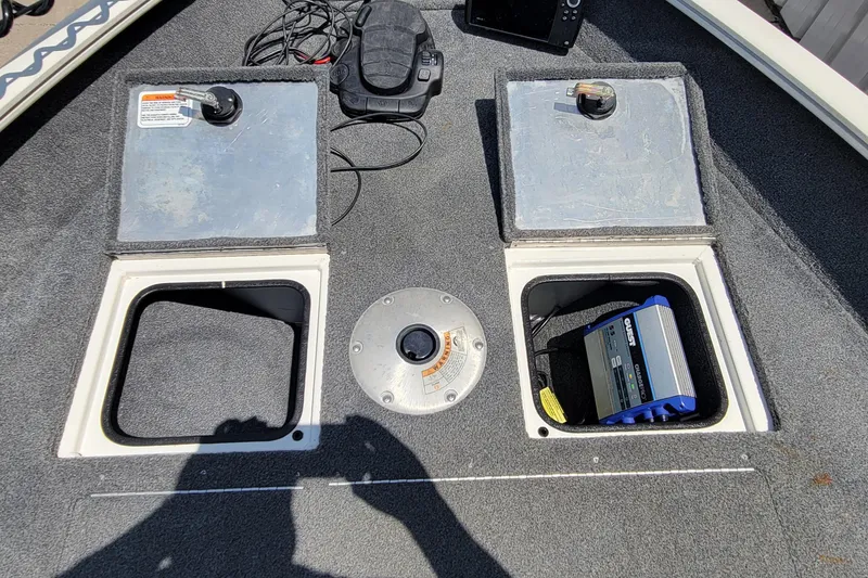 Slide: The Image of 2019 Tracker Pro Guide V-16 WT boat deck with storage compartments and electronic equipment. - 13
