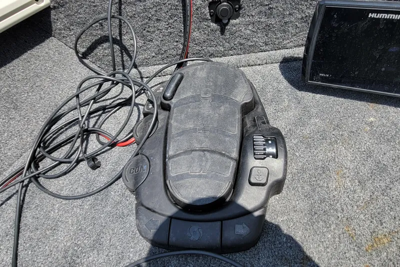 Slide: The Image of Foot pedal control on 2019 Tracker Pro Guide V-16 WT boat deck with cables and Humminbird Helix 7. - 15
