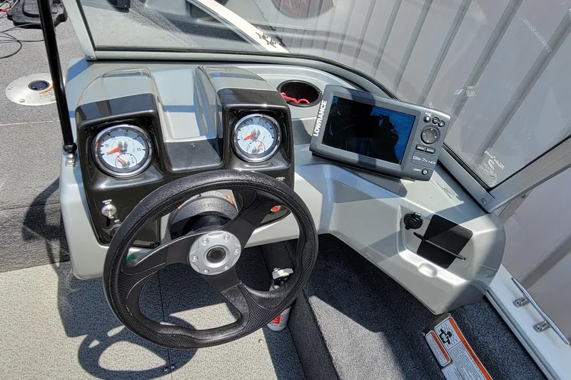 Slide: The Image of 2019 Tracker Pro Guide V-16 WT dashboard with steering wheel and Lowrance Elite-7 HDI fishfinder. - 18