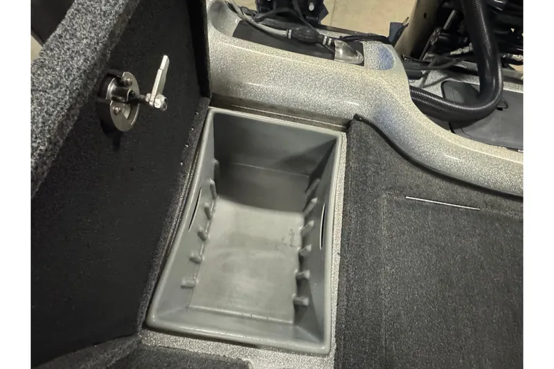 Slide: The Image of Interior storage compartment of a 2015 Nitro ZV21 boat, featuring a lock mechanism. - 15