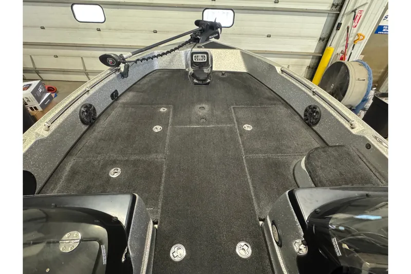 Slide: The Image of 2015 Nitro ZV21 boat interior with carpeted deck and mounted trolling motor. - 17