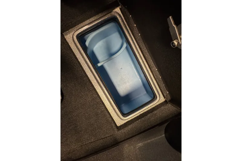 Slide: The Image of Storage compartment in a 2015 Nitro ZV21 boat, featuring a blue interior. - 22