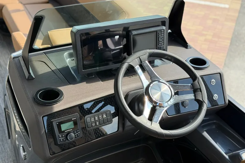 Slide: The Image of Steering console of 2027 Bennington 24 M Quad Bench boat with modern controls and display. - 15