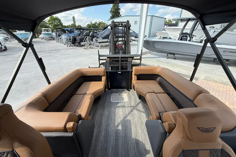 Slide: The Image of Luxurious interior of 2027 Bennington 24 M Quad Bench pontoon boat with tan seating. - 17