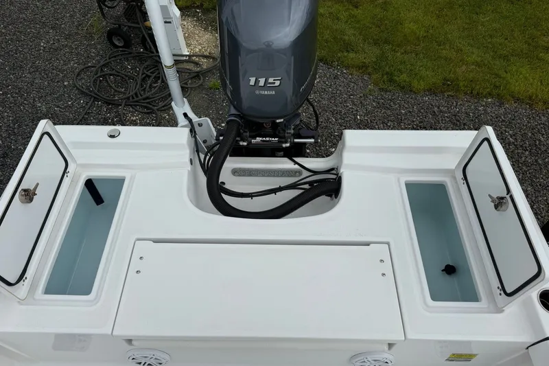 Slide: The Image of The image shows the stern of a Sportsman Masters 207 Bay Boat with a Yamaha 115 engine. - 14