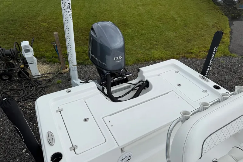 Slide: The Image of 2022 Sportsman Masters 207 Bay Boat with Yamaha 115 engine, parked on gravel. - 13