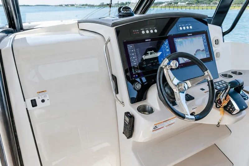 Slide: The Image of 2023 Boston Whaler 350 Realm helm with advanced navigation displays and controls. - 11